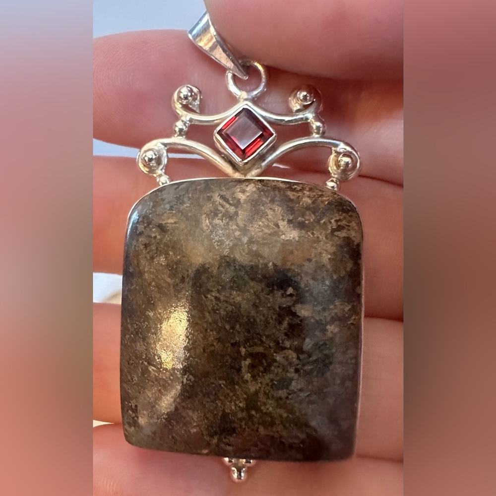 Sterling silver pendant featuring a rectangular moss agate and a square garnet.